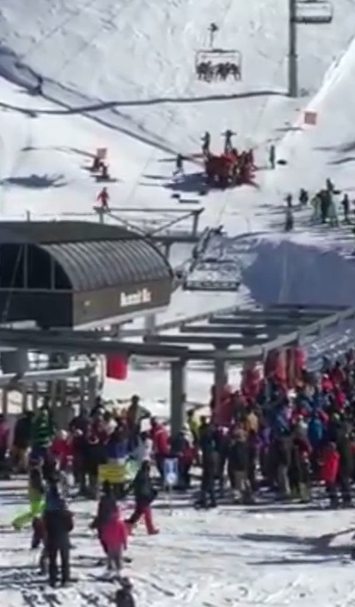 They caught the nine-year-old in a red safety blanket as they stood underneath him dangling from the chair