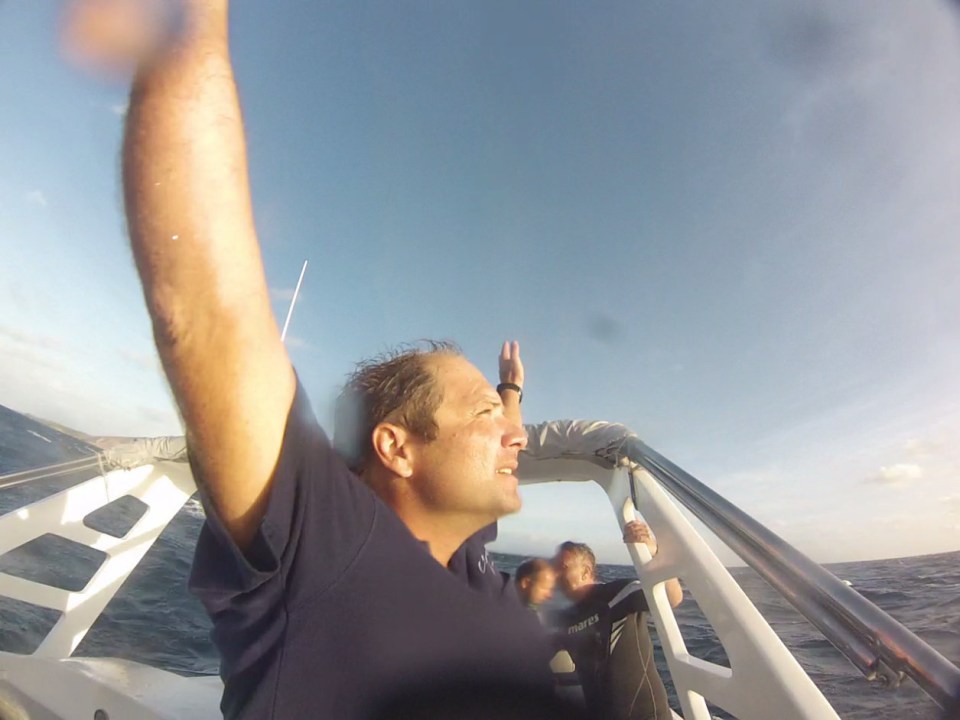One of the rescue party signalling to a passing helicopter after the group was picked up after being left in the water for seven hours