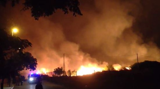 Emergency services are seen here bottom left trying to contain the blaze