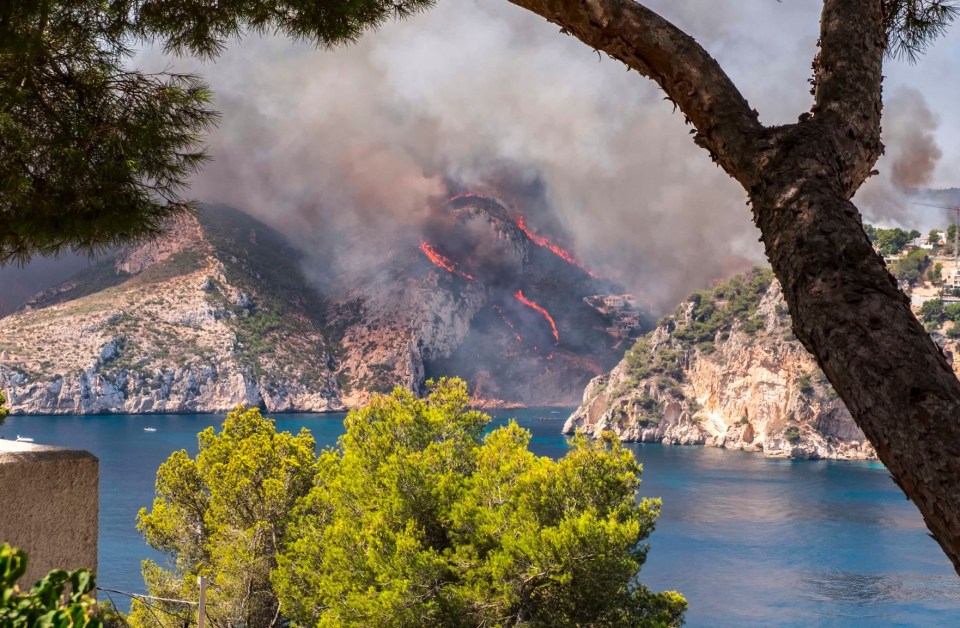 This wide shot shows the fires tearing up a mountainside
