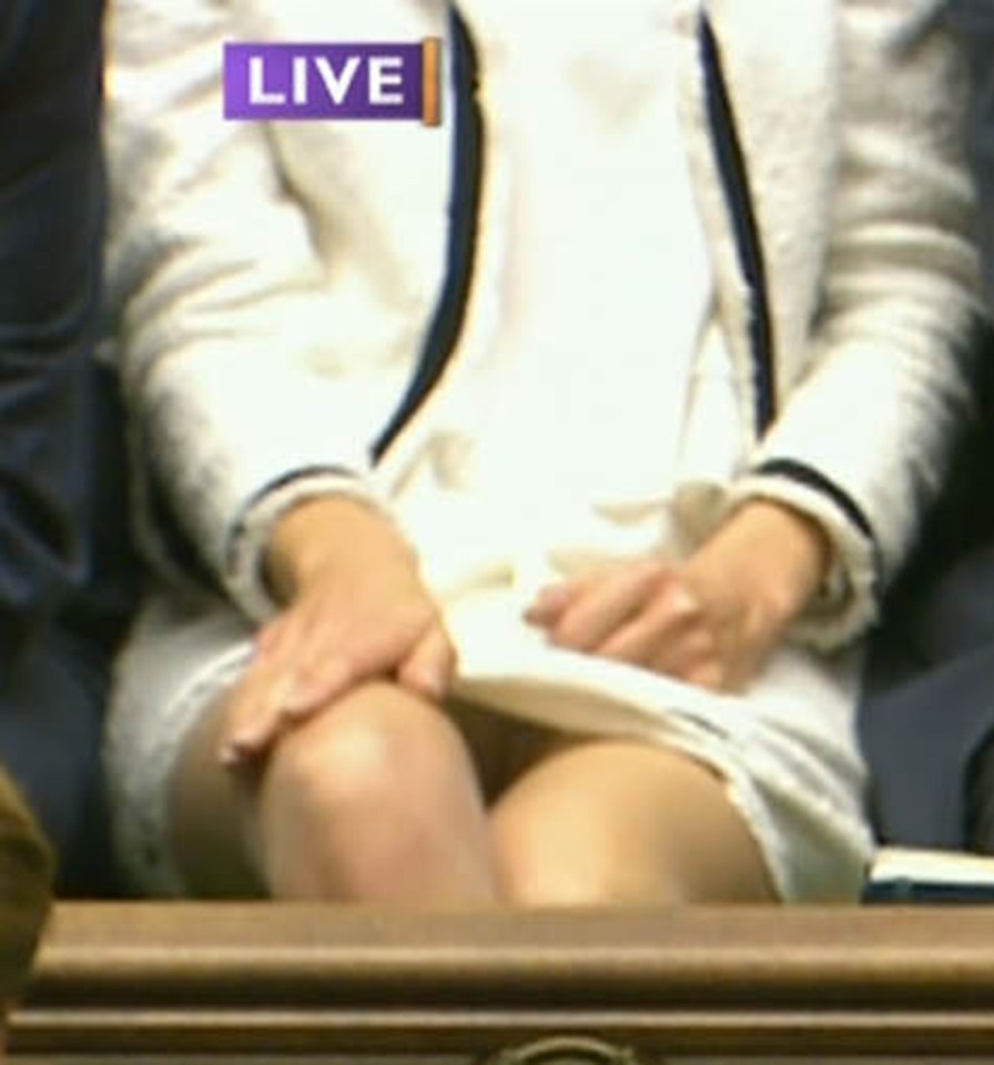 Lucy Frazer was trying to adjust her skirt when she showed off a lot of leg