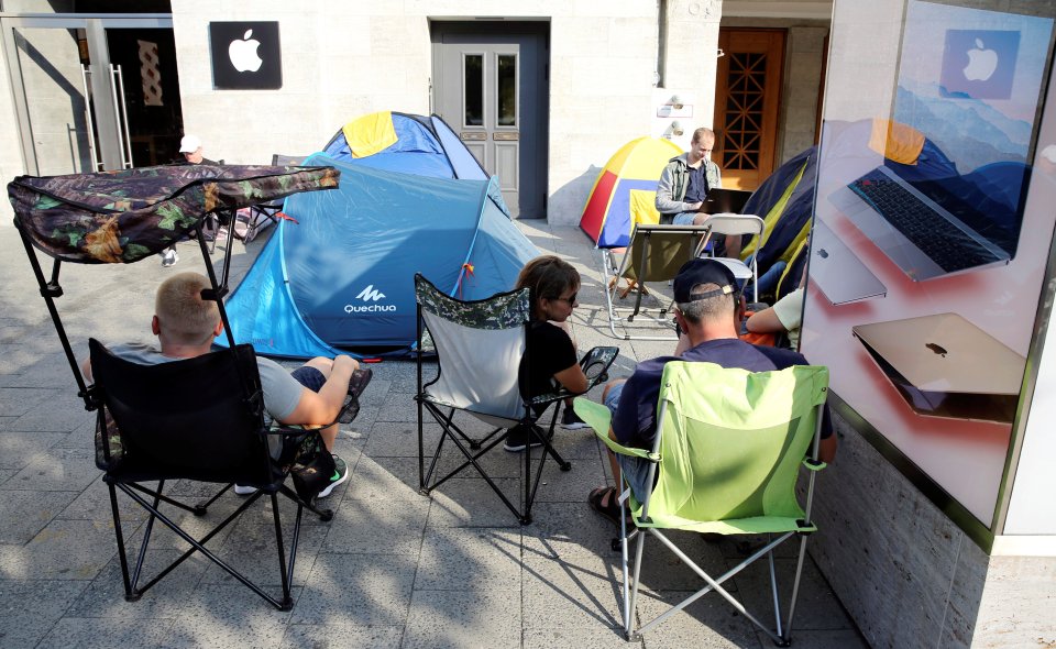 Customers wait beside their tents outside an Apple store to buy the newly released Apple iPhone 7 in Berlin