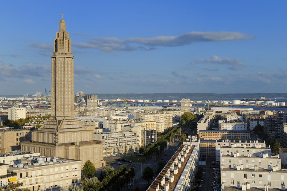 France, Seine Maritime, Le Havre, Downtown rebuilt by Auguste Perret, Perret buildings and St. Joseph's Church, the port in the background