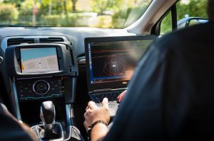 The technician monitors the robot car's performance