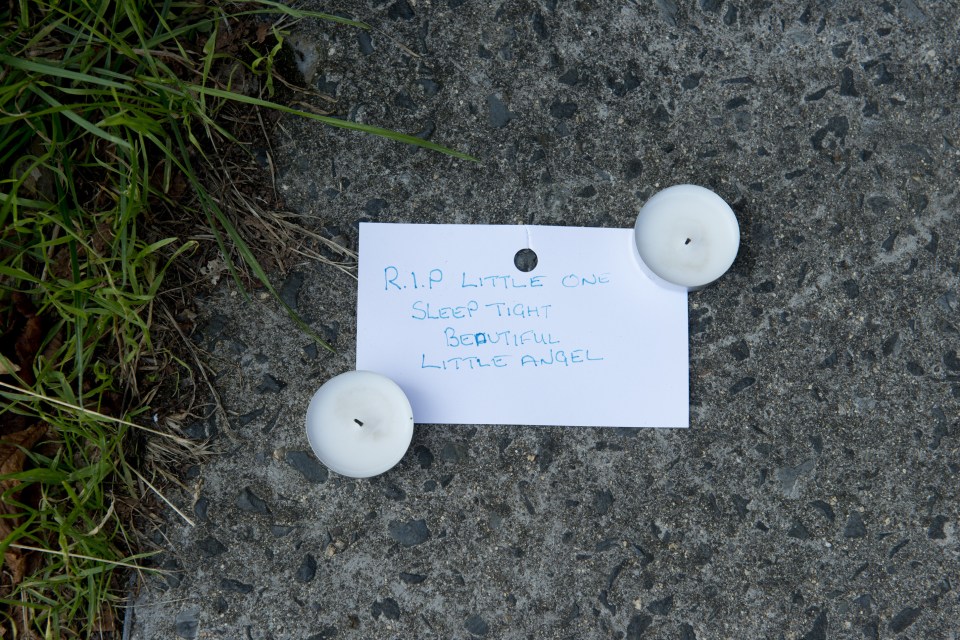 A tribute of flowers and candles were left at the scene