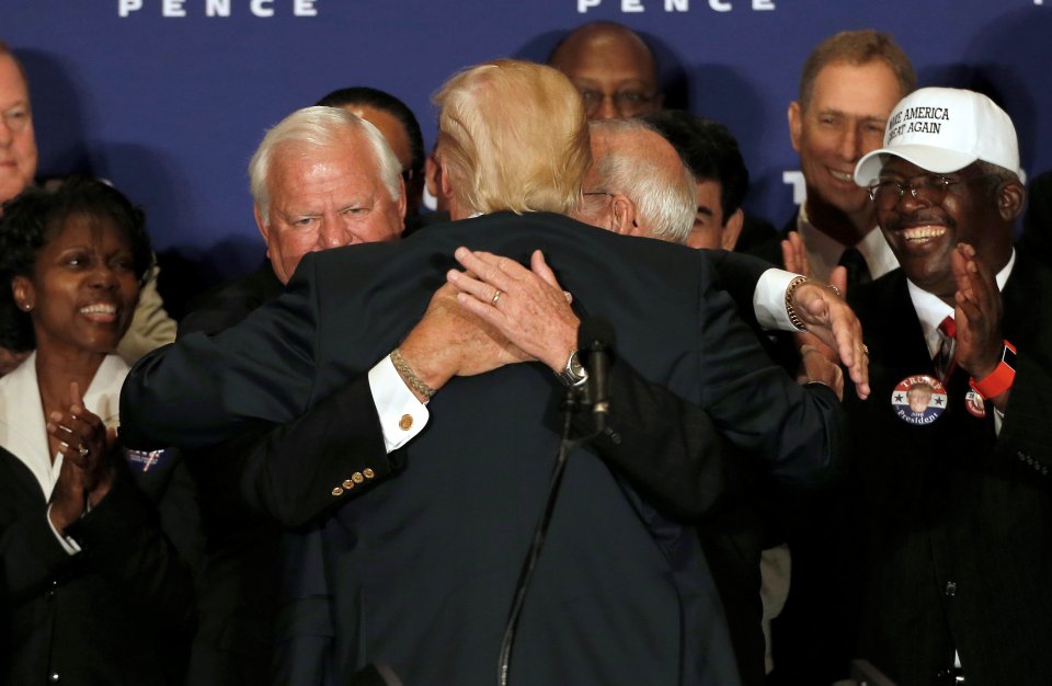 Republican presidential nominee Donald Trump hugs two Medal of Honor recipients at the event in Washington