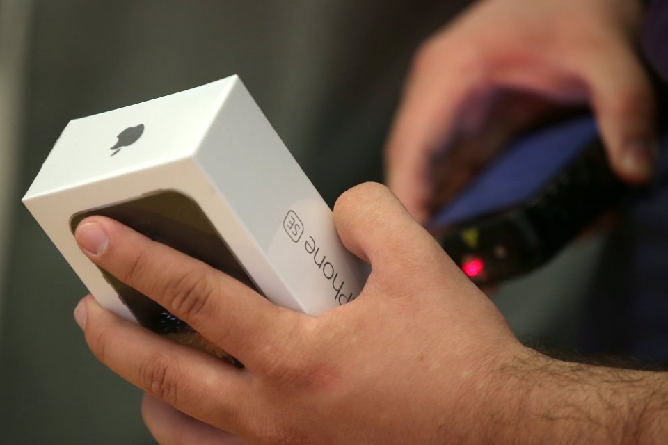 A customer buys the new iPhone 7 smartphone inside an Apple Inc. store in Los Angeles