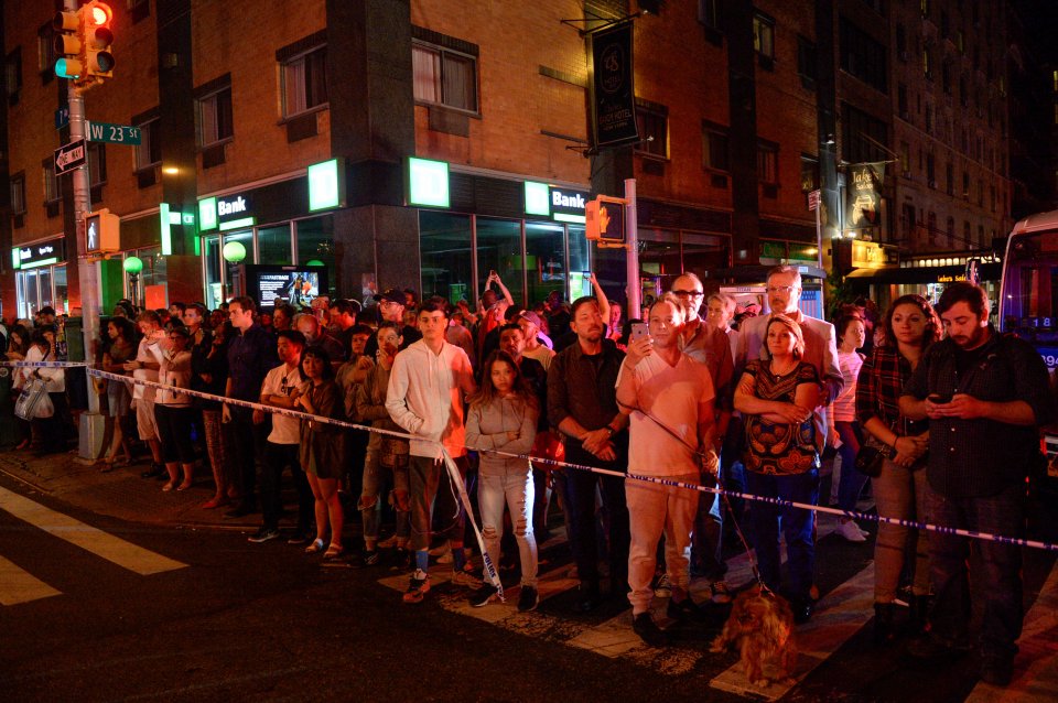 Onlookers stand behind a police cordon near the site of an explosion in Manhattan, New York