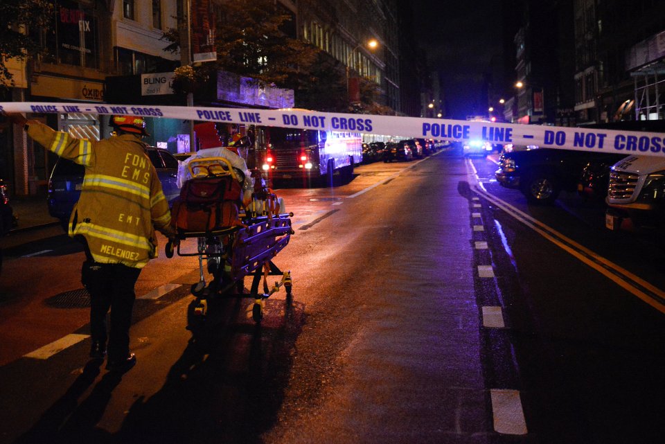 A New York City firefighter uses wheeled stretcher to carry supplies near site of explosion in New York