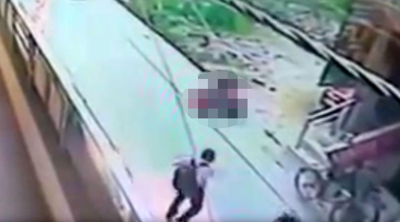 Numerous people are filmed walking along the street in the Burari area of Delhi during the attack