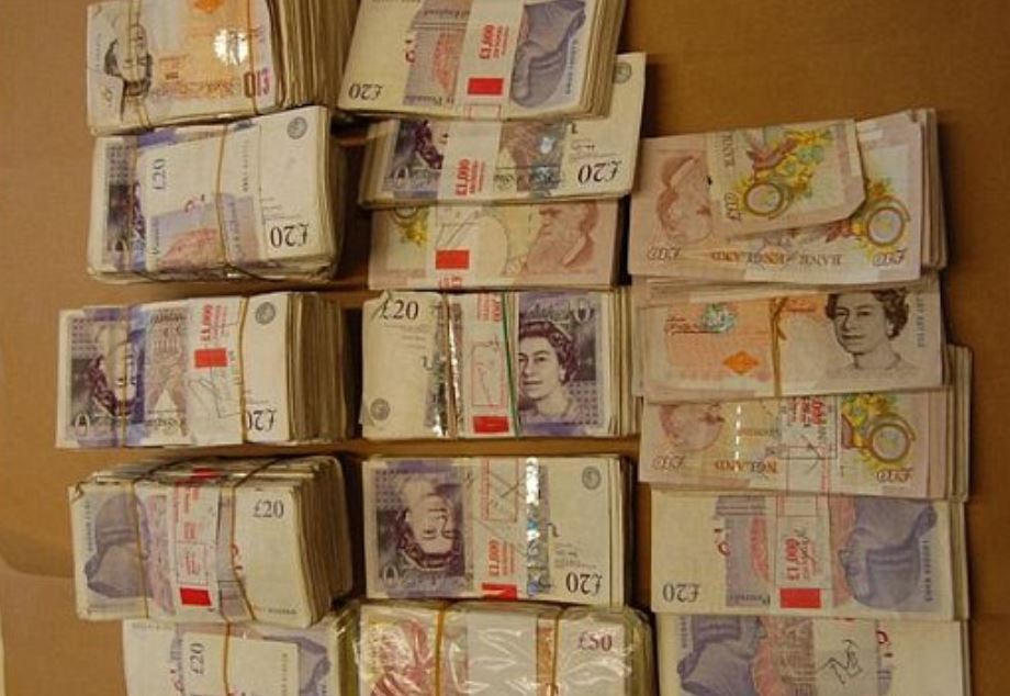 Piles of cash recovered by police after they caught the scheme where people would be conned out of bank details