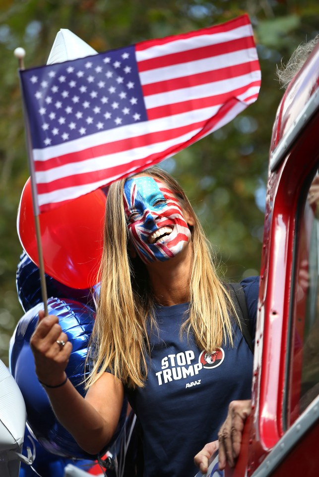 Ulrika Nisser has her face painted with the Union Jack and the Stars and Stripes as she joins activists aboard the Stop Trump campaign bus