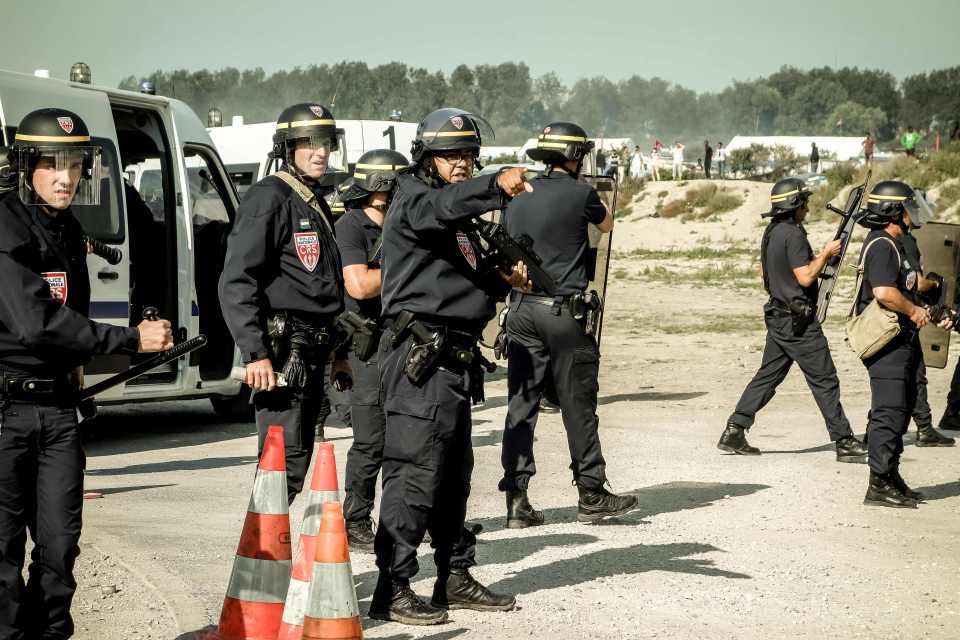 A police source said missiles were thrown at officers as migrants tried to reach nearby roads