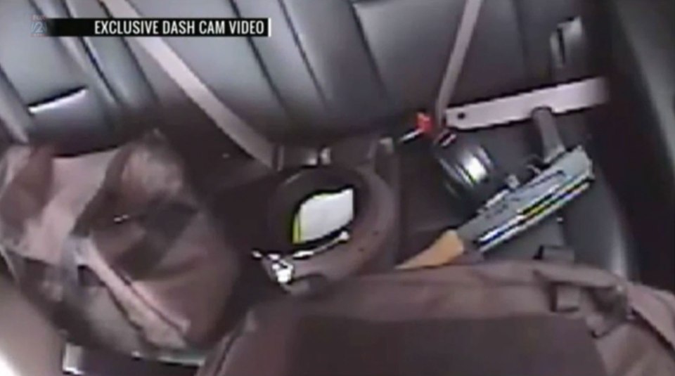 The AK-47 rifle can be seen on the back seat of the police vehicle after Stockley shot Smith