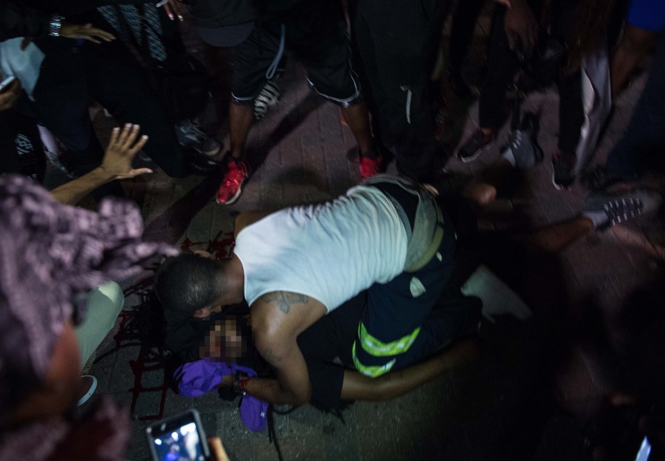 A man attends to a protester who was sho
