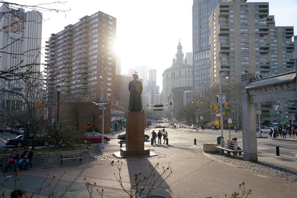 Chatham Square with statue of Lin Zexu and Kimlau Memorial Arch in Chinatown, Manhattan, New York City, USA