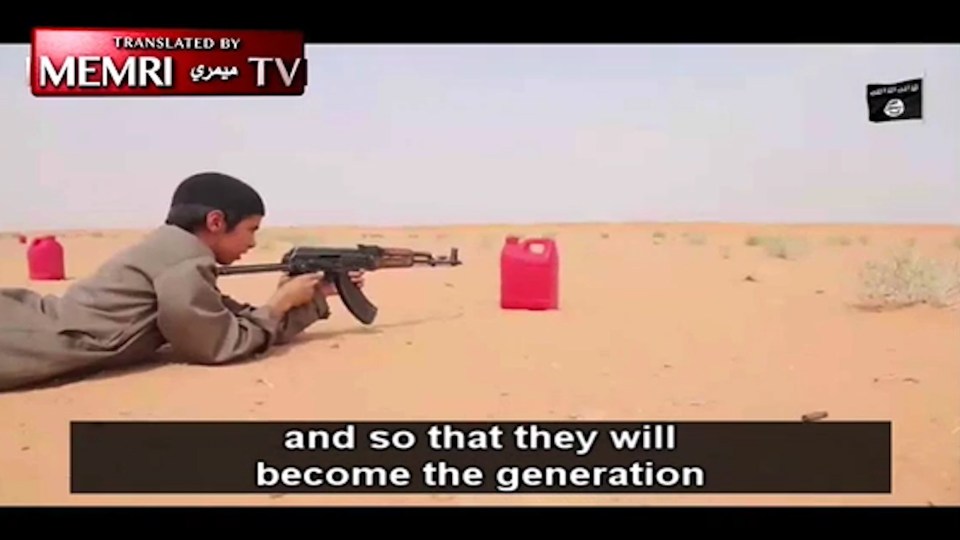 This boy is being taught how to wield a deadly Kalashnikov tifle