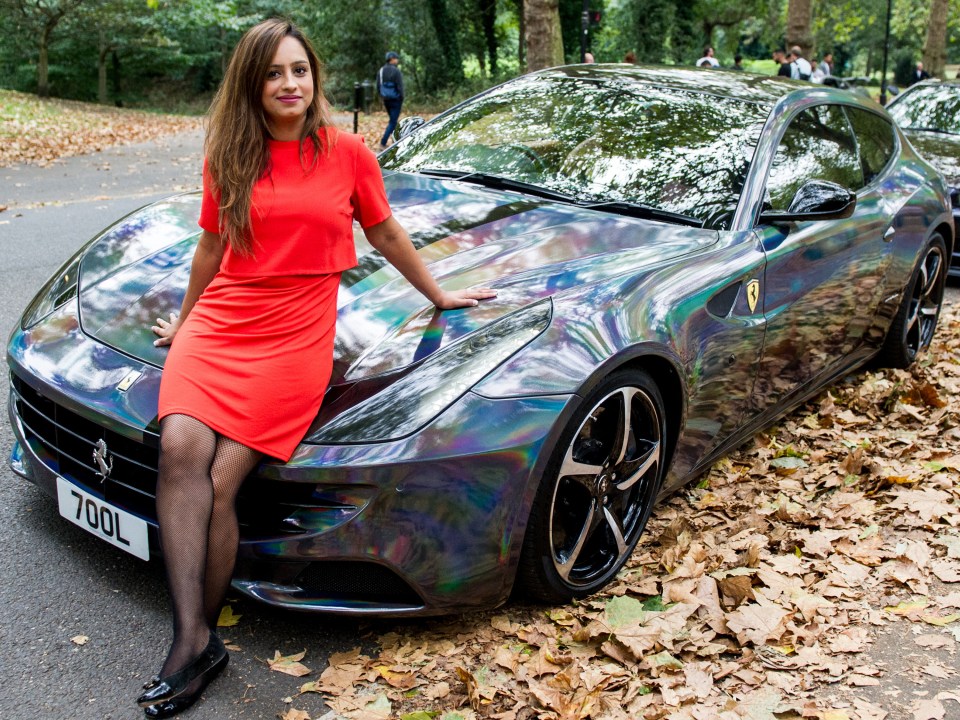 And it's not just men who are invited to the boy racers' club. Arty Tatter poses poses with her Ferrari here 