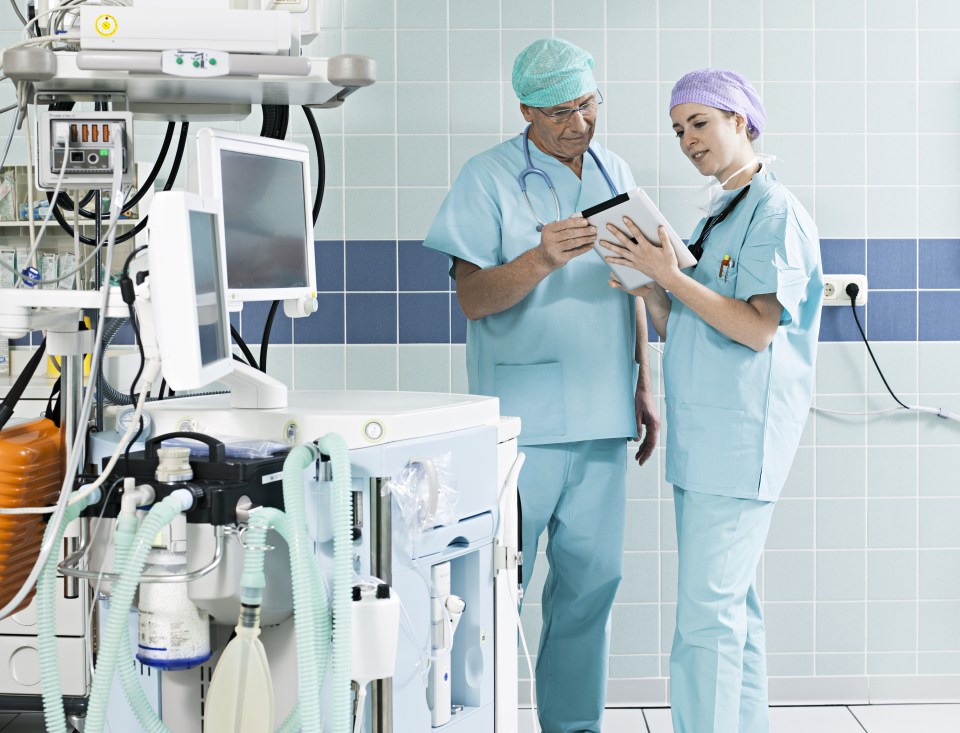 surgeons using digital tablet