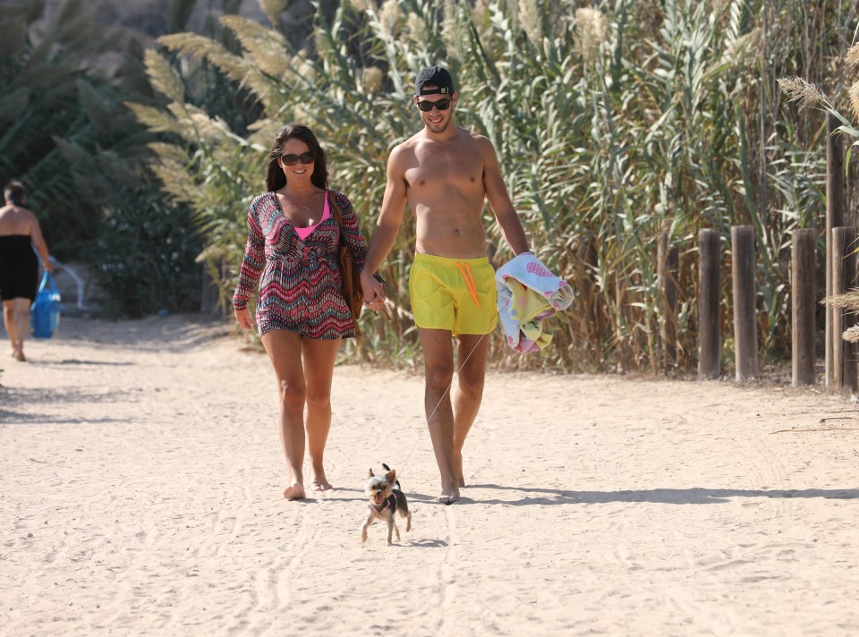 The two were joined by a little furry friend as they strolled along the sand