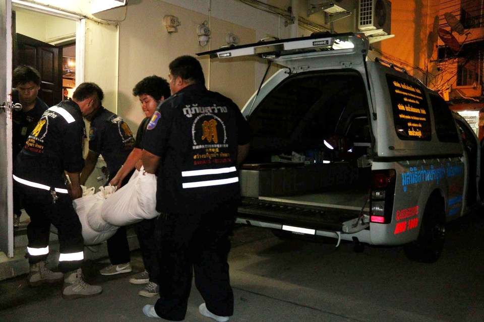 Police seen carrying the body into an ambulance