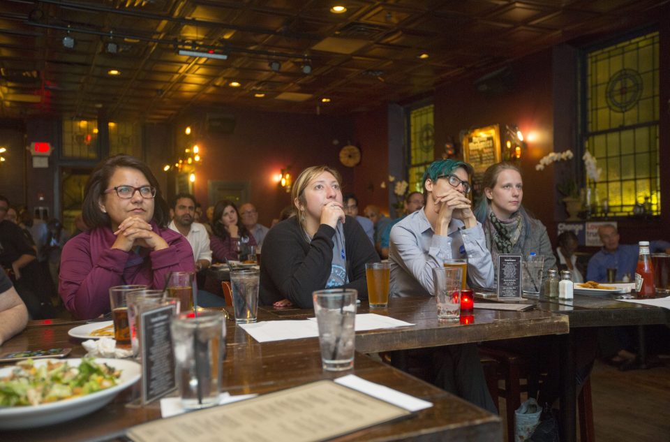 Potential voters watch the first presidential debate between Democratic nominee Hillary Clinton and Republican nominee Donald Trump at a bar in Philadelphia, Pennsylvania