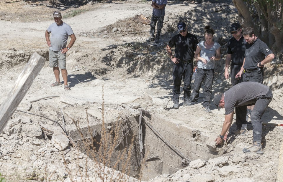 Police remove the top of a septic tank as they search for missing tot Ben Needham