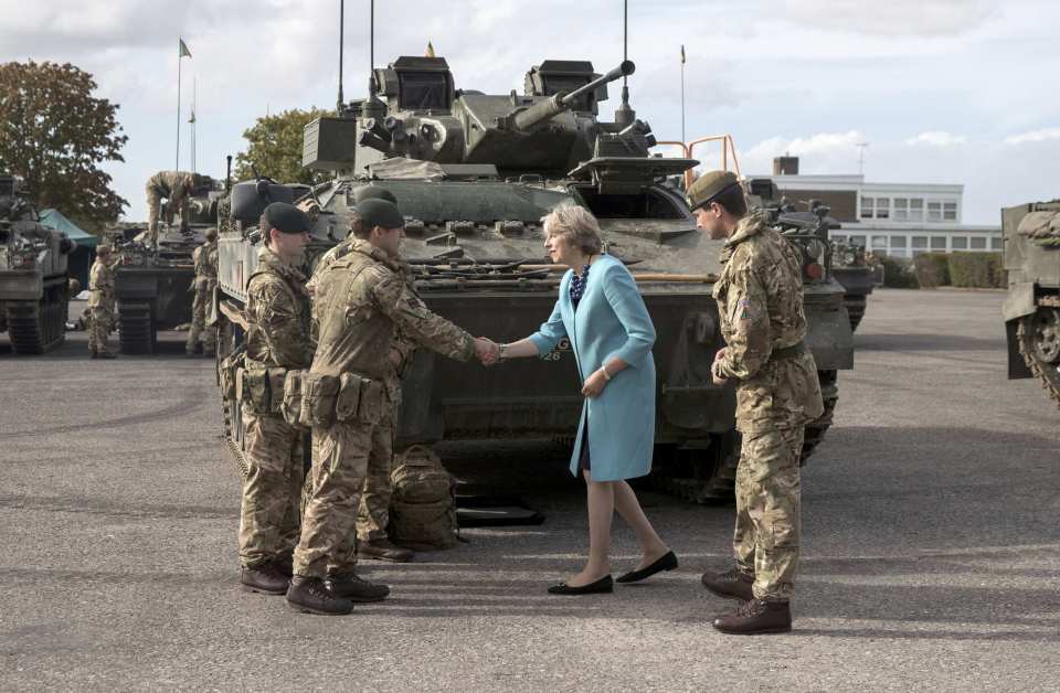 PM handshake . . . Theresa May gives boost to troops on visit