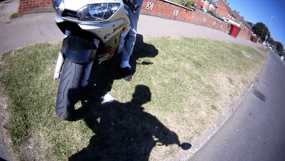 The cyclist and motorbike rider start arguing after both went through the roundabout in Reading