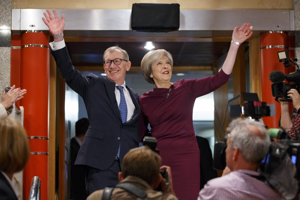 She gives one final wave as she and her husband leave the conference hall