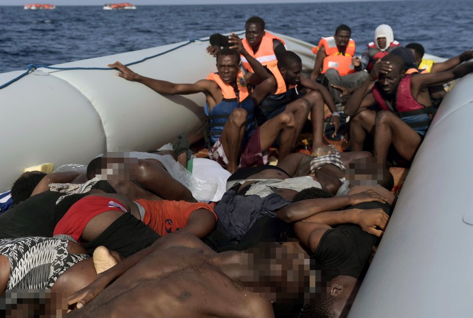  Graphic content / Dead bodies lie on a boat after Europe-bound migrants were rescued by members of Proactiva Open Arms NGO in the Mediterranean Sea, some 12 nautical miles north of Libya, on October 4, 2016. Twenty-eight Europe-bound migrants were found dead on a day of frantic rescues off Libya, including at least 22 in an overloaded wooden boat, an AFP photographer and the Italian coastguard said. / AFP PHOTO / ARIS MESSINISARIS MESSINIS/AFP/Getty Images