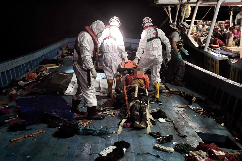 Members of Proactiva Open Arms NGO evacuate a dead body on a stretcher during a rescuing operation