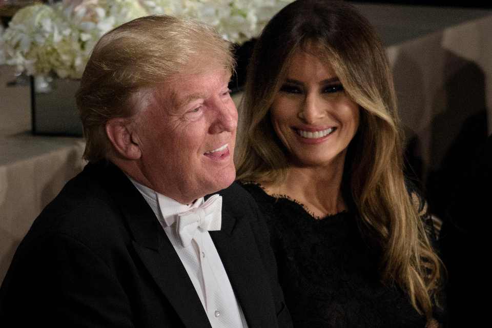 Republican presidential nominee Donald Trump and Melania Trump laugh during the Alfred E. Smith Memorial Foundation Dinner at Waldorf Astoria October 20, 2016 in New York, New York. / AFP PHOTO / Brendan SmialowskiBRENDAN SMIALOWSKI/AFP/Getty Images