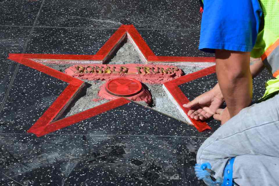 Donald Trump's vandalized Star along the Hollywood Walk of Fame is repaired and cleaned up before being replaced on October 26, 2016 in Hollywood, California. A man defaced Republican presidential candidate Donald Trump's star on the Hollywood Walk of Fame Wednesday, hacking out the gold lettering displaying his name and the television logo. A man who identified himself to a local news agency as James Lambert Otis, said he vandalized the tribute with a sledgehammer and pickaxe, originally intended to remove the entire star from the sidewalk on Hollywood Boulevard. / AFP PHOTO / Frederic J. BROWNFREDERIC J. BROWN/AFP/Getty Images