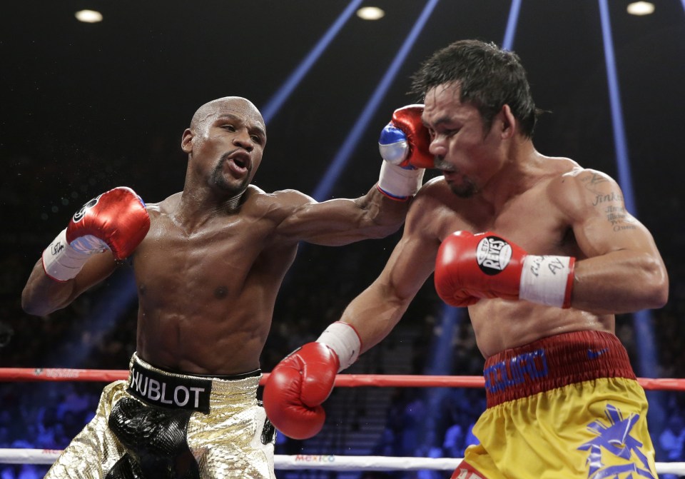 Money match . . . Mayweather lands a hit on Pacquiao during their much-hyped bout