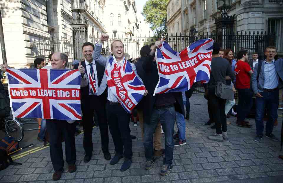 of Vote Leave supporters waving Union flags, following the result of the EU referendum, outside Downing Street in London
