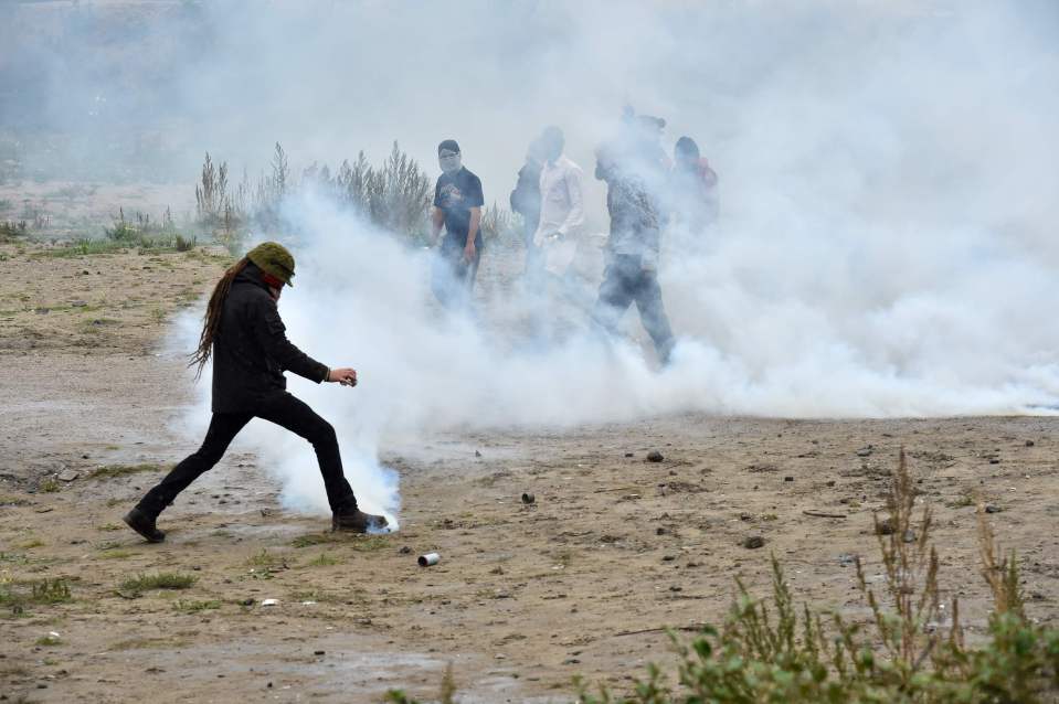 Smoke bombs are fired during clashes bet