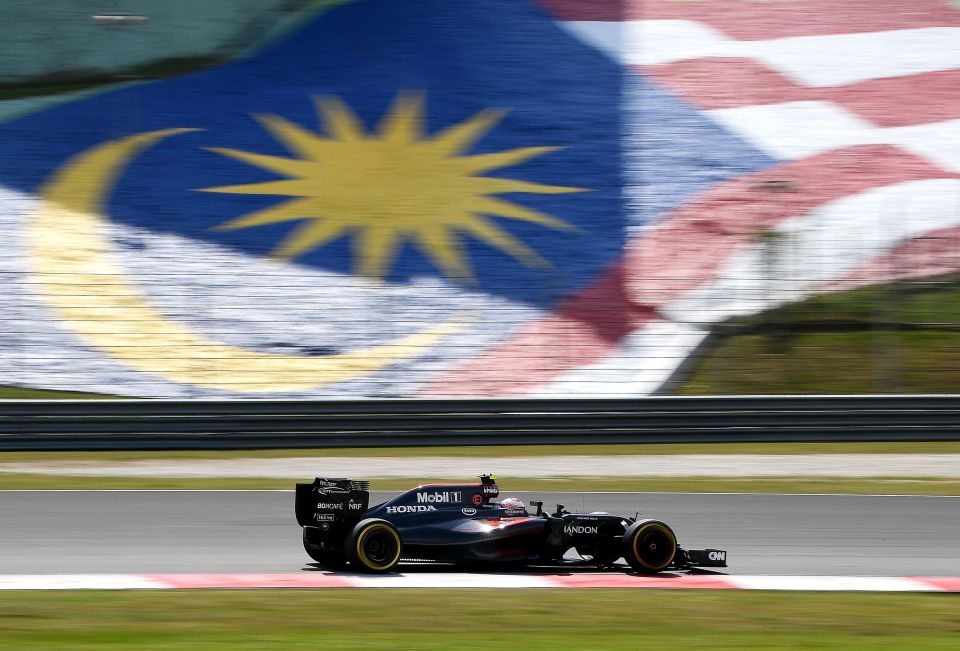 McLaren Honda's Spanish driver Fernando Alonso powers his car during the Formula One Malaysian Grand Prix 