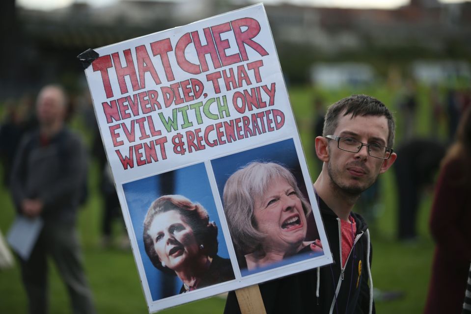 An anti-Conservative protester with a pl