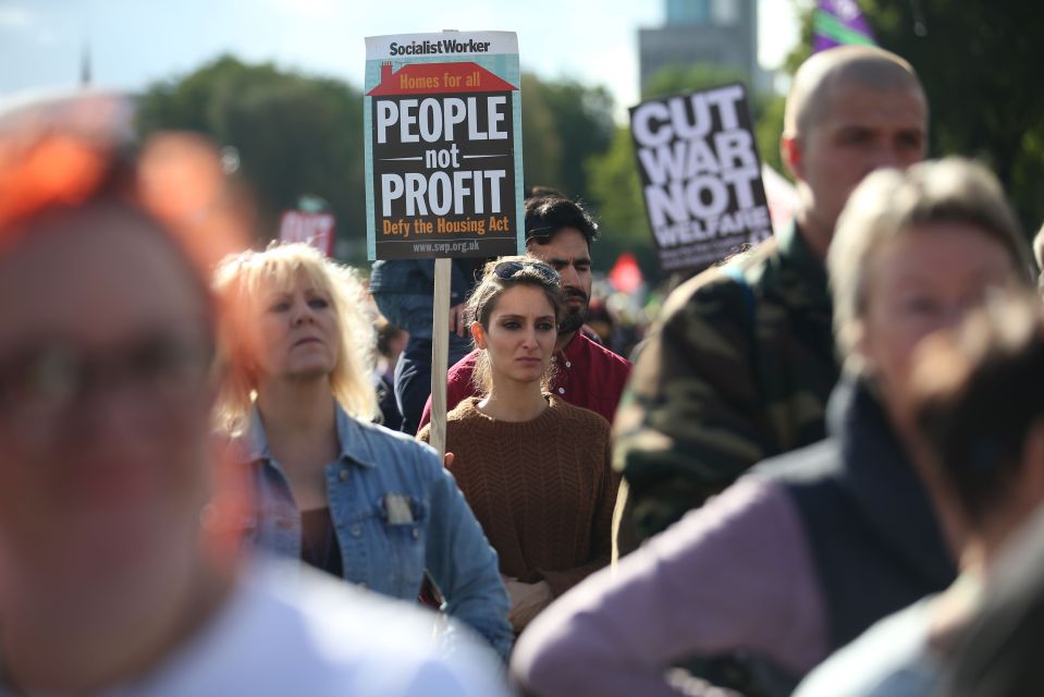 Anti-Conservative protesters with a plac