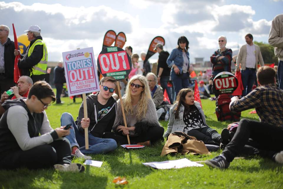 Anti-Conservative protesters with a plac