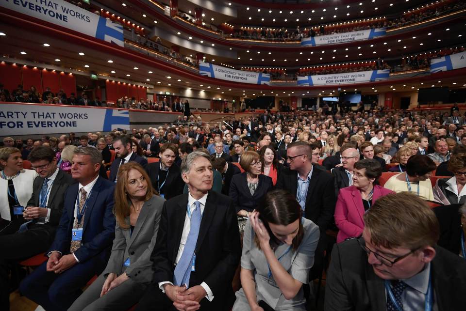 Britain's Chancellor of Exchequer Philip Hammond watches Prime Minister Theresa May speak at the annual Conservative Party Conference in Birmingham
