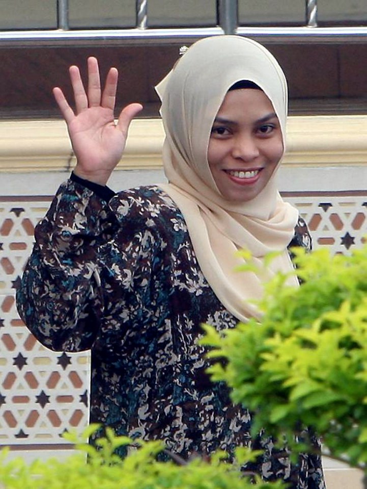 Kartika Sari Dewi Shukarno waves to journalists as she leaves the Islamic religious office in Pekan