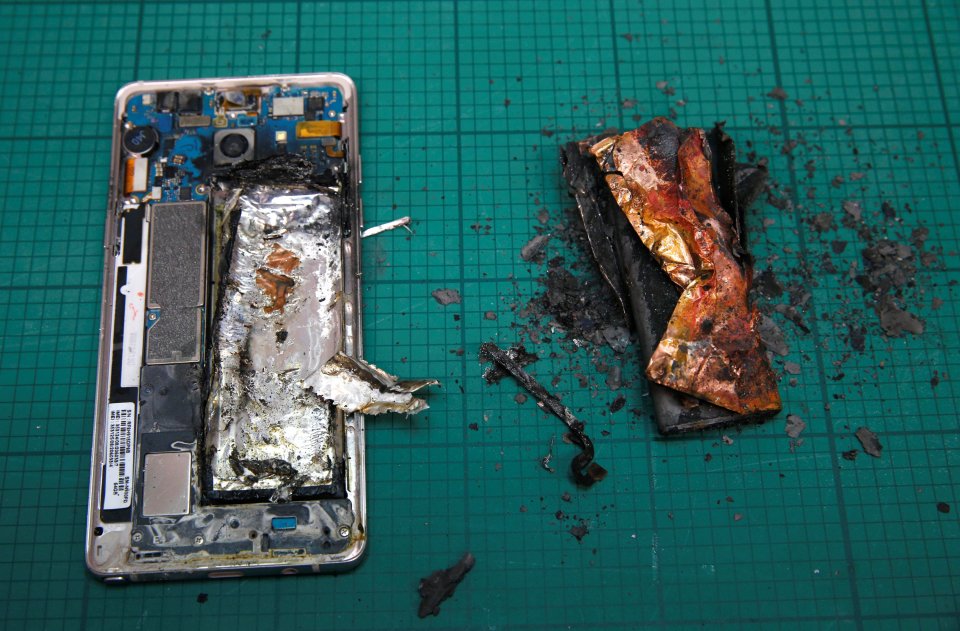 A Samsung Note 7 handset is pictured next to its charred battery after catching fire during a test at the Applied Energy Hub battery laboratory in Singapore