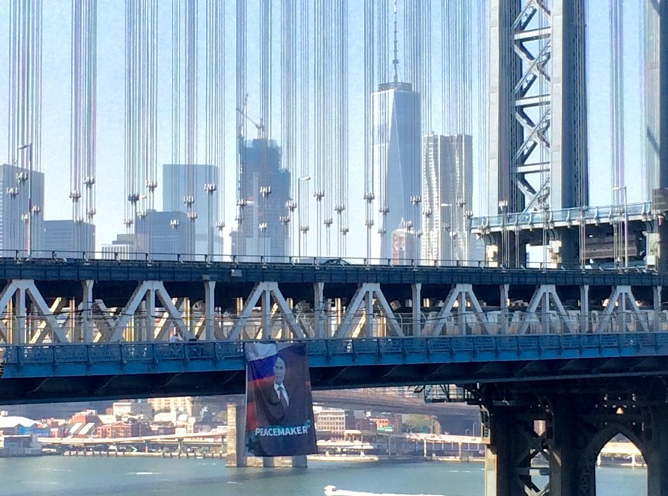 A banner with an image of Russian President Vladimir Putin hangs from the Manhattan Bridge in New York City