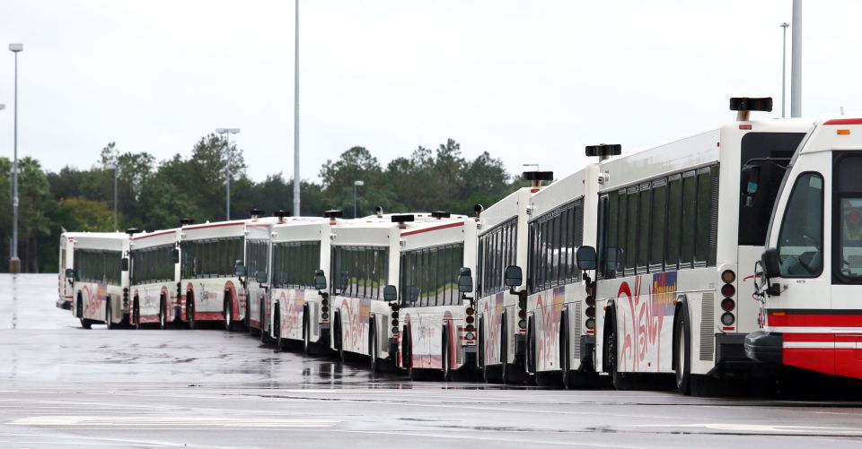 Transport buses sit in an empty parking lot after riding out the storm