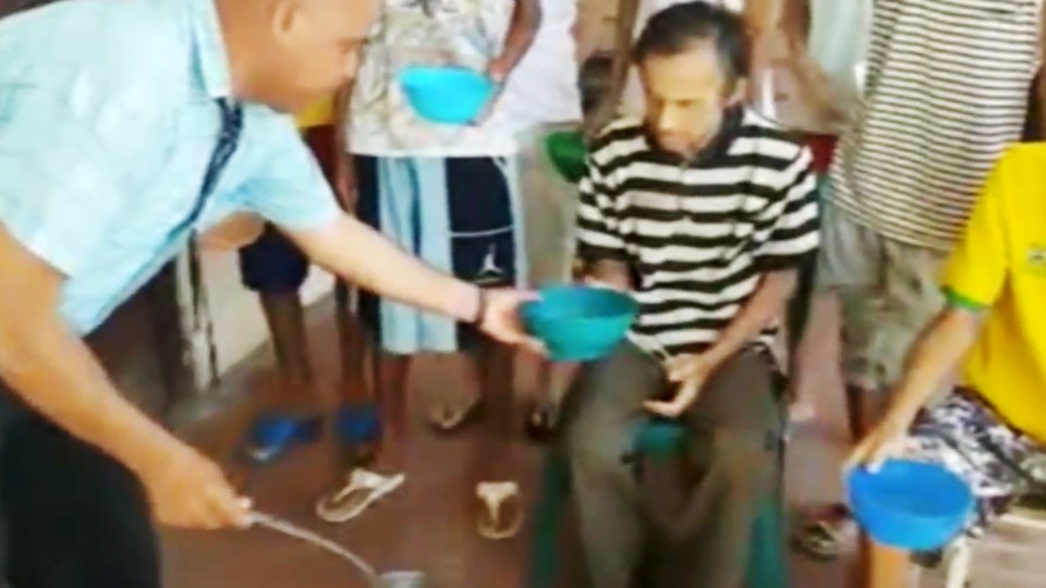 Images also show prisoners being given food