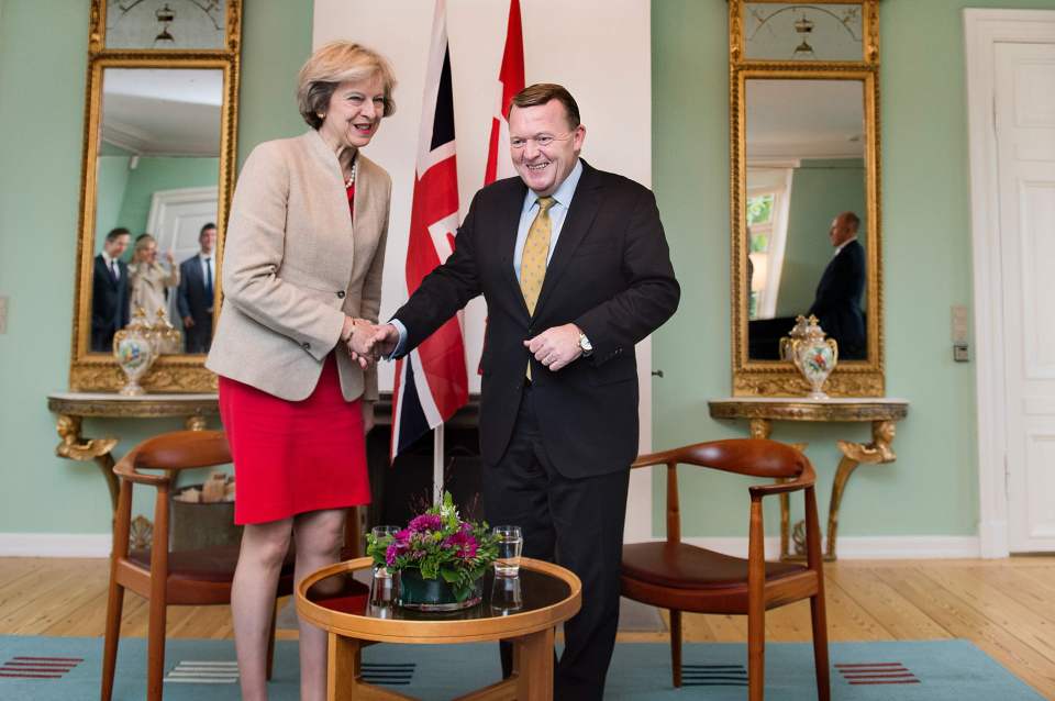 The pair shake hands during Mrs May's visit at the Marienborg estate outside Copenhagen today