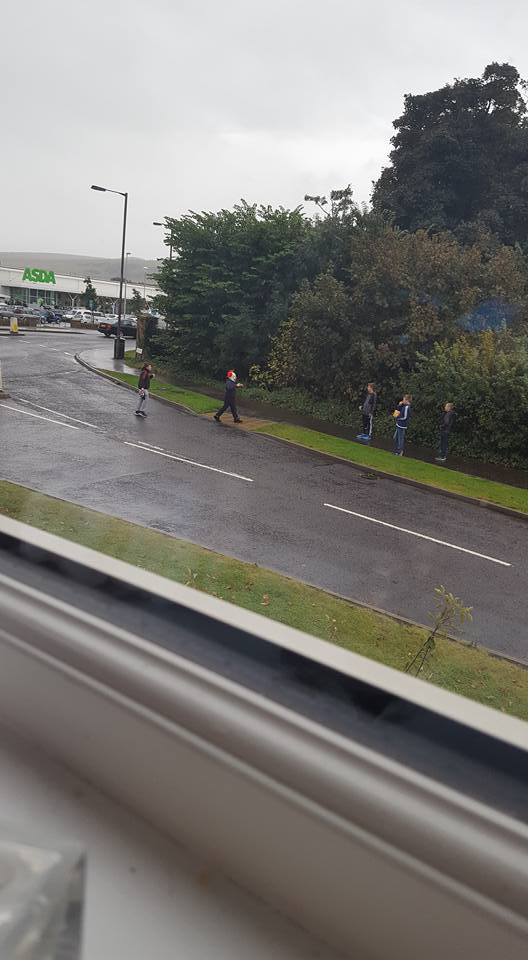 A killer clown approaches a group of school kids as they walk down the road in Dunbar, East Lothian 