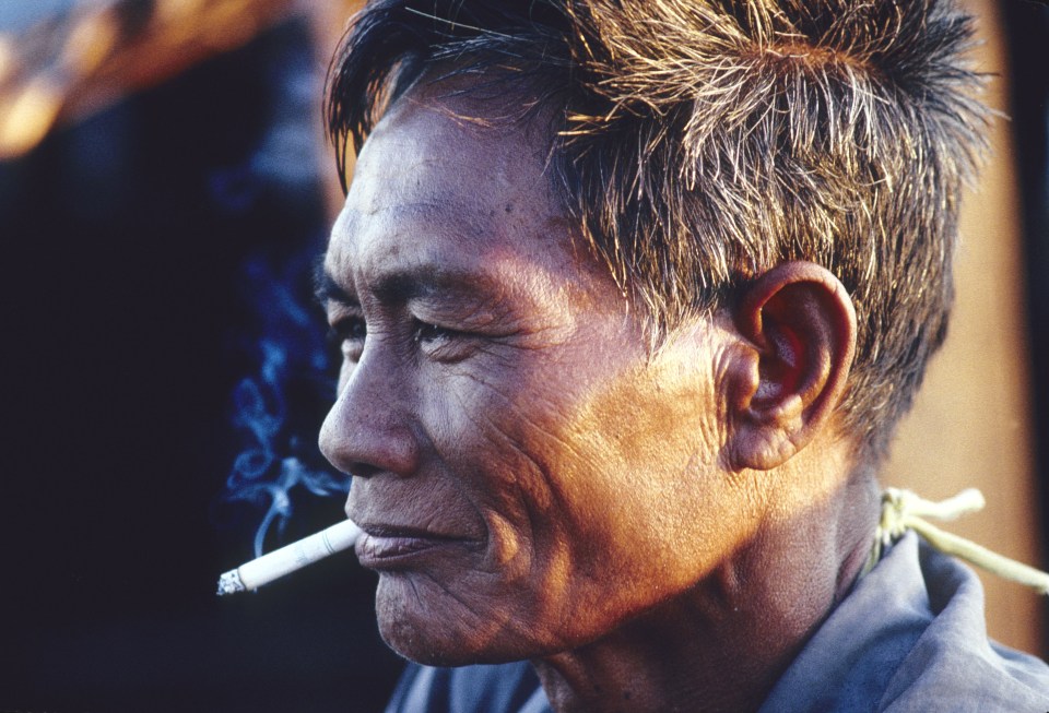 PHL, Philippines, Sulu sea: A Badjao man smokes a cigarette on the island of Bongao.